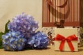 Birthday gifts wrapped in bag and box with bow and blue hydrangea flowers bouquet Royalty Free Stock Photo