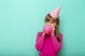Birthday girl blowing a balloon Royalty Free Stock Photo