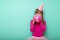 Birthday girl blowing a balloon Royalty Free Stock Photo