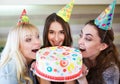 Birthday. Girls bite cake at a birthday party