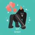 Birthday greeting card with a funny gorilla in a cap and with balloons