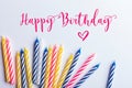 Birthday greeting card. With very colorful candles red, yellow, white and blue on a white background. Royalty Free Stock Photo
