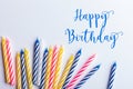 Birthday greeting card. With very colorful candles red, yellow, white and blue on a white background. Royalty Free Stock Photo