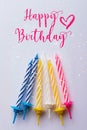 Birthday greeting card. With very colorful candles red, yellow, white and blue on a white background. With text Happy Birthday Royalty Free Stock Photo