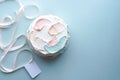 Birthday holiday cake with and pink ribbon with card on blue background
