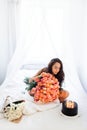 Birthday morning of young woman with huge bouquet of roses and tasty cake Royalty Free Stock Photo