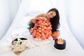 Birthday morning of young woman with huge bouquet of roses and tasty cake Royalty Free Stock Photo