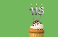 Birthday card with candle number 115 - Cupcake on green background