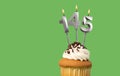 Birthday card with candle number 145 - Cupcake on green background