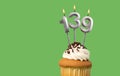 Birthday card with candle number 139 - Cupcake on green background Royalty Free Stock Photo