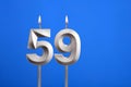 Birthday number 59 - Candle lit on blue background