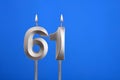 Birthday number 61 - Candle lit on blue background