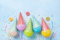 Birthday or party background. Funny balloons, candy and confetti on blue table top view. Flat lay. Invitation card.