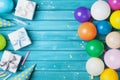 Birthday party banner or background with colorful balloon, gift, carnival cap, confetti and candy. Copy space. Royalty Free Stock Photo