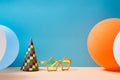 Birthday party. Children holiday. Celebration party. Holiday cap, funny glasses and colourful balloons, copy space