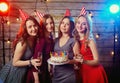 Birthday party girlfriends. Women light candles on the cake with Royalty Free Stock Photo