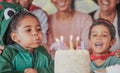 Birthday, party and happy family with girl and candle on cake for celebration, gift and announcement. Wow, support and Royalty Free Stock Photo