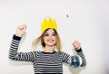 Birthday party, new year carnival. Young smiling woman on white background celebrating brightful event, wears stripped Royalty Free Stock Photo