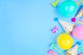Birthday party side border on a blue background with confetti, balloons, party hats and streamers Royalty Free Stock Photo