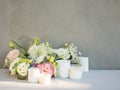 Birthday party or wedding flower arrangement with candles, white and pink roses.