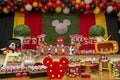 Birthday reception. Sweet table decorated with Mickey Mouse theme