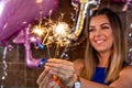 Radiant Birthday Celebration: Close-up of a Sparkler in the Hand of a Woman