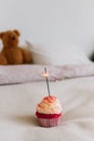 Birthday surprise cupcake with sparkle on bed