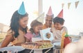 Birthday, surprise and family outdoors for party, celebration and present, happy and excited. Parents, children and gift