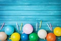 Birthday table with colorful balloons, confetti and candles top view. Party background. Festive greeting card.