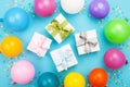 Birthday table with colorful balloons, gift or present box and confetti top view. Flat lay. Royalty Free Stock Photo