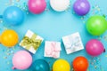 Birthday table with colorful balloons, gift or present box and confetti top view. Flat lay composition. Royalty Free Stock Photo