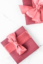 Coral gift box with silk bow on marble background, girl baby shower present and glamour fashion gift for luxury beauty brand, Royalty Free Stock Photo