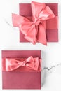 Coral gift box with silk bow on marble background, girl baby shower present and glamour fashion gift for luxury beauty brand, Royalty Free Stock Photo