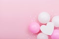 Birthday or wedding mockup with white heart shape, confetti and pastel balloons on pink table from above. Flat lay composition. Royalty Free Stock Photo