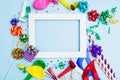 Birthday white frame with party accessories on blue background. Copy space Royalty Free Stock Photo