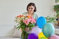 Birthday, 45 years old, happy female with bouquet of flowers and balloons Royalty Free Stock Photo