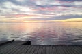 Biscarrosse sunrise wooden pontoon with water reflection sunset sun in lake