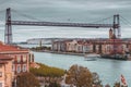 Biscay bridge flying with gondola over river Nervion. Portugalete landmark. Famous bridge called Puente de Vizcaya near Bilbao. Royalty Free Stock Photo