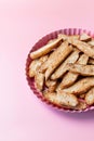 Biscotti with nuts on pink background. Delicious cantucci cookies. Cantuccini. Traditional italian homemade biscuits. Royalty Free Stock Photo