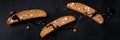 Biscotti panorama. Traditional Italian almond cookies, shot from the top on a black background