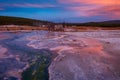 Biscuit basin with purple reflection on a steamy water and beautiful colorful sunset. Yellowstone, Wyoming