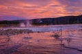 Biscuit basin with purple reflection on a steamy water and beautiful colorful sunset. Yellowstone, Wyoming