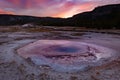 Biscuit basin walkway with blue steamy water and beautiful colorful sunset. Yellowstone, Wyoming