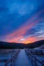 Biscuit basin walkway with blue steamy water and beautiful colorful sunset. Yellowstone, Wyoming Royalty Free Stock Photo