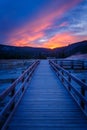 Biscuit basin walkway with blue steamy water and beautiful colorful sunset. Yellowstone, Wyoming Royalty Free Stock Photo