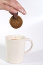 Biscuit being dipped in tea