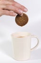 Biscuit being dipped in tea