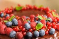 Biscuit cake with beautiful berries strawberries, raspberries, blueberries, currant and mint Royalty Free Stock Photo