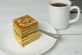 Biscuit cake  on the plate and cup of coffee on wooden table Royalty Free Stock Photo