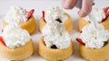 Biscuit cakes with fresh berries, chocolate, and whipped heavy cream.